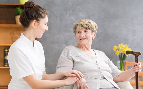 Nurse with a smiling elderly woman