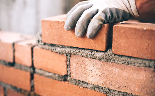 Bricklayer laying bricks